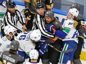 Vegas Golden Knights right winger Ryan Reaves (75) and Vancouver Canucks left winger Antoine Roussel (26) are separated during a scuffle in Game 5 of their second round playoff series on Tuesday, Sept. 1, 2020 at Rogers Place.