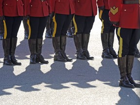 RCMP officers line up before a memorial for fallen mounties at RCMP Depot in Regina, Sask., on Sunday, Sept. 13, 2015. The Alberta government is looking to hire a contractor and an executive manager for a proposed provincial police force that would replace the RCMP.