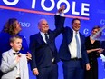 Newly elected Conservative Leader Erin O'Toole has his hand hoisted by outgoing leader Andrew Scheer as he stands his wife and children after delivering his winning speech following the Conservative party of Canada 2020 Leadership Election in Ottawa, Aug. 24, 2020.