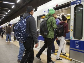 Passengers ride the LRT at Churchill Station in Edmonton.