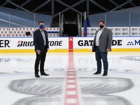 Oilers Entertainment Group senior vice-president of communications Tim Shipton, left, and senior vice-president of operations Stu Ballantyne stand at centre ice in the middle of the Hub City bubble at Rogers Place, where the NHL playoffs wrapped up on Monday, Sept. 28, 2020, only to turn around and do it all over again for the upcoming International Ice Hockey Federation world junior championships.