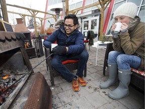Cafe Bicyclette staff take a break on the restaurant's patio, 8627 91 St., during Edmonton's Winter Patio Kick-Off Weekend on Dec. 2, 2017.