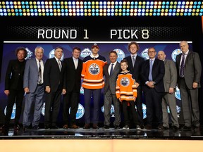 Edmonton Oilers owner Daryl Katz, left, and his son, Harrison, fourth from right, welcome the eighth-overall selection of the 2019 NHL Entry Draft in Vancouver on June 21, 2019.