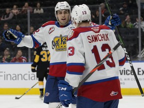 The Edmonton Oil Kings' Matthew Robertson (22) and Riley Sawchuk (13) celebrate a goal against the Brandon Wheat Kings at Rogers Place on Jan. 28, 2020,