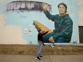 Former Edmonton Football Club equipment manager Dwayne Mandrusiak waves to a reporter following an interview at the Joey Moss mural along 99 Street near 72 Avenue, in Edmonton on Tuesday Oct. 27, 2020. Moss, the long-time dressing room attendant of the Edmonton Oilers and Edmonton Football Club, died Monday.