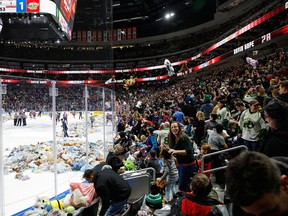 Fans throw teddy bears on the ice after Davis Koch of the Edmonton Oil Kings scored against the Prince Albert Raiders during the 2017 Teddy Bear Toss at Rogers Place on Dec. 2, 2017. Just how many fans will be allowed in the stands in 2021 remains to be seen.