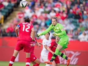 Canadian goalkeeper Erin McLeod, right, knocks away a shot during Canada's FIFA Women's World Cup Group A match against New Zealand at Commonwealth Stadium on June 11, 2015.