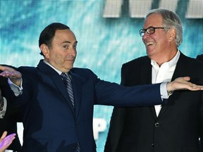 NHL commissioner Gary Bettman, left, encourages people to boo him next to Vegas Golden Knights majority owner Bill Foley at T-Mobile Arena in this file photo from Nov. 22, 2016, in Las Vegas.