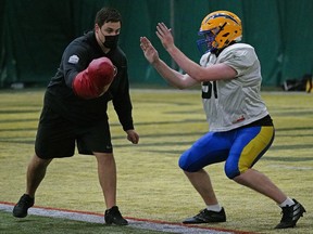 University of Alberta Golden Bears football product Mark Korte (left), now an offensive lineman with the Ottawa Redblacks, returned to Foote Field in Edmonton to help university football head coach Chris Morris coach the Elite 80 high school football camp on Saturday, October 24, 2020.