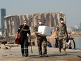 Members of the Lebanese army and the French military walk at the damaged site of the massive blast in Beirut's port area, in Beirut, Lebanon August 31, 2020.