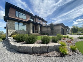 Creating a terraced effect in Ian Ball's front yard works well for rain flow, and the artificial turf reduces the watering requirements. SUPPLIED BY SALISBURY LANDSCAPING