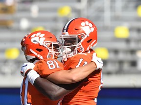 Harry Ainlay Titans high-school product Ajou Ajou (11) celebrates with fellow Clemson Tigers wide receiver Drew Swinney (81) after scoring his first NCAA touchdown against the Georgia Tech Yellow Jackets at Bobby Dodd Stadium, on Saturday, Oct. 17, 2020.