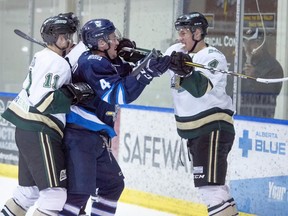 Dylan Holloway, right, gets in a shoving match with the Canmore Eagles' Jared Bowman during an Alberta Junior Hockey League game while playing for the Okotoks Oilers in this file photo from Feb. 12, 2019. Holloway, currently playing NCAA Div. 1 hockey in Wisconsin, was selected 14th overall by the Edmonton Oilers in Tuesday's NHL draft.