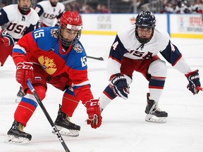 Russia's Daniil Gushchin (15) is pursued by the United Mitchell Miller (4) during Hlinka Gretzky Cup action in Edmonton on Saturday, August 11, 2018.