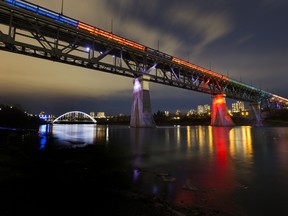 The High Level Bridge is lit in blue and orange, of the Edmonton Oilers, as well as green and gold of the Edmonton Footbal Club, in honour of shared locker-room attendant Joey Moss, who died Monday age 57.
