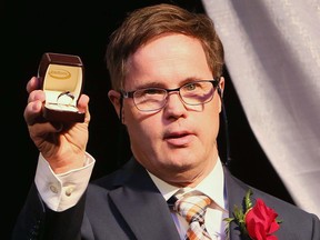 Legendary Edmonton Oilers and Edmonton Football Club locker-room attendant Joey Moss proudly shows off his ring at the 2015 Alberta Sports Hall of Fame induction gala in Red Deer on May 29, 2015.