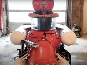 Submarine builder Hank Pronk sits inside a one-man submarine he refurbished during the pandemic. it's now for sale on Calgary classifieds.