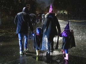 People go trick or treating in the rain on Halloween in Ottawa, on Thursday, Oct. 31, 2019.