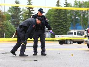 Police investigate the scene of a serious assault at a strip mall in the 2000 block of 32nd avenue N.E. in Calgary on July 2, 2018. Gavin Young/Postmedia