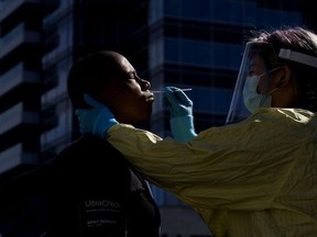 Community paramedic Katrina Petrosky performs COVID-19 nasal swab testing outside Boyle Street Community Services, in downtown Edmonton Wednesday Sept. 9, 2020.