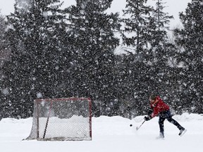 Andre Lessard plays hockey as a heavy snow falls in Edmonton's Hawrelak Park Thursday Feb. 9, 2020.