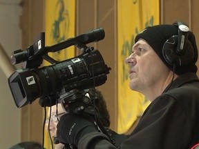 Rob Zittlau films a University of Alberta hockey game at Clare Drake Arena in this undated file photo taken over the last decade. On Sunday, he and his wife, Grace, died in a highway collision near Legal, Alta.