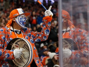 A fan cheers at Rogers Place as the Edmonton Oilers play the visiting Carolina Hurricanes during NHL action on Dec. 10, 2019.