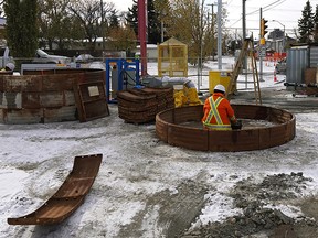Workers repair a sink hole that opened up on the road on 61 Avenue at 109 Street in south Edmonton. The hole is approximately 5-storeys deep and will take months to repair. Traffic is being re-routed until the repair is completed.
