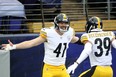 Pittsburgh Steelers linebacker Robert Spillane celebrates with free safety Minkah Fitzpatrick after returning an interception for a touchdown.