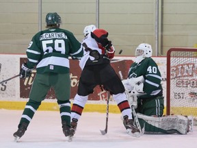 Sherwood Park Crusaders goaltender Carson Cherepak makes a save on Camrose Kodiaks forward Lynden Grandberg while defenceman Brandon McCartney looks on in an AJHL exhibition game at the Sherwood Park Arena on Sunday, Nov. 8, 2020.