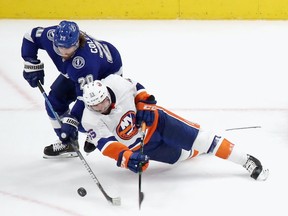 Johnny Boychuk #55 of the New York Islanders has his skate blade broken by a shot during the game against Blake Coleman #20 of the Tampa Bay Lightning in Game 5 of the Eastern Conference Final during the 2020 NHL Stanley Cup Playoffs at Rogers Place on September 15, 2020.