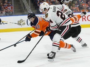 Edmonton Oilers forward Ryan Nugent-Hopkins (93) gets some air against the Chicago Blackhawks' Dominik Kahun (24) at Rogers Place in this file photo from Nov. 1, 2018.
