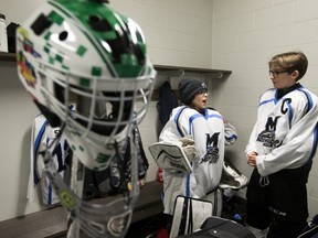 Mill Woods Bruins' Michael Whittington, left, and Zak Tkachuk, 11, talk strategy prior to the opening game of the Quikcard Edmonton Minor Hockey Week against at the Meadows Community Recreation Centre in this file photo from Jan. 9, 2019. New provincial COVID-19 restrictions are shutting down hockey at the minor levels for two weeks.