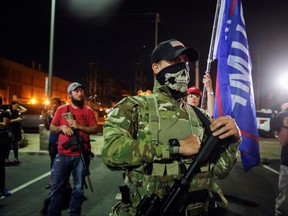 Supporters of U.S. President Donald Trump carry semi-automatic rifles as they gather during a protest about the early results of the 2020 presidential election, in front of the Maricopa County Tabulation and Election Center (MCTEC), in Phoenix, Ariz., Nov. 5, 2020.