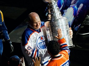 Don Jackson greets fans with the Stanley Cup during the NHL's Greatest Team celebration recognizing the 1984-85 Edmonton Oilers team at Rogers Place in Edmonton on Sunday, Feb. 11, 2018.