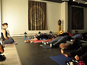 Alyssa Schmidt, founder and co-owner for 4Points Health and Wellness, left, conducts a yoga class prior to the first wave of COVID-19 restrictions in March, 2020.