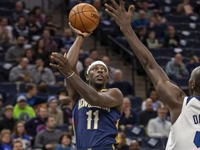 New Orleans Pelicans guard Jrue Holiday (11) shoots the ball over Minnesota Timberwolves center Gorgui Dieng (5) in the first half at Target Center.