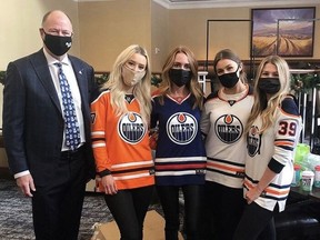 Oilers Entertainment Group vice-chairman Kevin Lowe poses with participants in the gingerbread house competition held Monday at the Fairmont Hotel MacDonald. Supplied