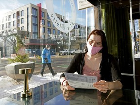 Continental Treat Fine Bistro employee Christine Champagne sits alone in the Whyte Avenue restaurant on Wednesday, Nov. 25, 2020, the day after the Alberta government imposed restrictions throughout the province to curb the spread of COVID-19 infections.