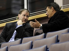 Edmonton Oilers executive Kevin Lowe, left, speaks with then-Detroit Red Wings general manager Ken Holland in this file photo taken in Edmonton on Feb. 26, 2008. The two are part of the 2020 Hockey Hall of Fame class.