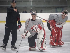 CP-Web.  Canada's goaltenders Joel Hofer, centre, and Nico Daws, right, listen to Team Canada goaltending coach Jason LaBarbera instructs Joel Hofer, centre, and Nico Daws during practice at the world junior hockey championships on Dec. 29, 2019 in Ostrava, Czech Republic.