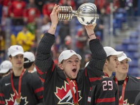 Canada's Bowen Byram celebrates with the trophy after defeating Russia in the gold-medal game at the world junior hockey championships on Jan. 5, 2020, in Ostrava, Czech Republic.