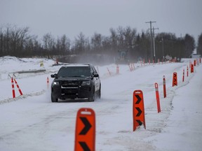 A police cruiser heads north on 17 Street in southeast Edmonton on Thursday, Nov. 19, 2020.