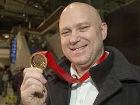 Following a long flight Team Canada assistant coach and Ottawa 67's head coach André Tourigny shows off the gold medal upon arriving at the Ottawa Airport. Canada beat Team Russia 4-3 at the world junior championships in the Czech Republic on Jan. 5, 2020.