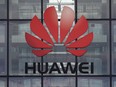 In this file photo taken April 29, 2019, the Huawei logo and signage is seen at their main U.K. offices in Reading, west of London.