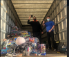 Can Man Dan (left) and Toys “R” Us manager Matt Jobb inside truck collecting toys.