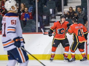 Calgary Flames forward Jakob Pelletier (49) celebrates a goal by Matthew Phillips he assisted on against the Edmonton Oilers during the Battle of Alberta prospects game at Scotiabank Saddledome on Sept. 10, 2019.
