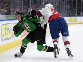 Matthew Robertson of the Edmonton Oil Kings checks Prince Albert Raiders defenceman Kaiden Guhle during the WHL’s Eastern Conference Championship in April 2019.