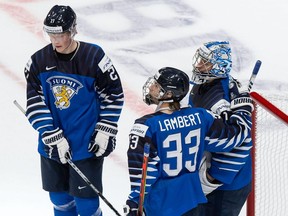 Juuso Parssinen (No. 27), Brad Lambert (No. 33) and goaltender Kari Piiroinen of Finland celebrate their victory over Germany during the 2021 IIHF World Junior Championship at Rogers Place on December 25, 2020.
