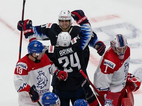Bobby Brink (24) and Matthew Beniers (10) of the United States celebrate a goal against goaltender Lukas Parik (1) of the Czech Republic during the 2021 IIHF world junior championships at Rogers Place on Dec. 29, 2020. in Edmonton, Canada.